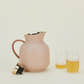 Stelton Amphora Vacuum Tea Jug in Soft Peach with two glass cups