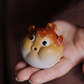 Hand holding a Clay Pufferfish Tea Pet