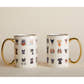 Two Mugs illustrated with Various Cats Wearing Accessories Porcelain with Gold Handles on a tan background