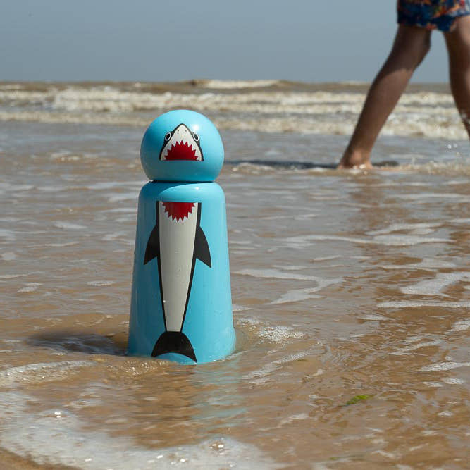 Shark Skittle Stainless Steel Bottle on a beach in the waves