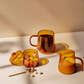 Amber glass jar with Good Citizen Coffee Co Sugar Cubes, a mug with coffee and creamer jar