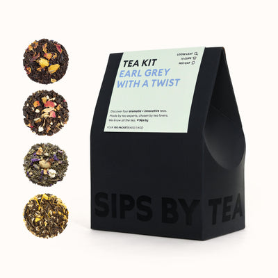 Black box with green topper with black and purple text that says - "Sips by Earl Grey With A Twist Tea Kit - Loose Leaf, Mix-Caf, Top-Rated - Discover four aromatic + innovative teas. Made by tea experts, chosen by tea lovers. We know all the tea. Love Sips by. Makes 16 Cups. Four 10G Packets (40G) (1.4OZ)"