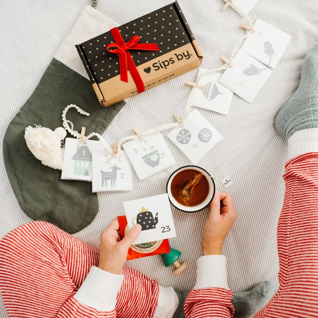 DIY 24-Day Tea Advent Calendar cards, cup of tea, and sips by box with bow