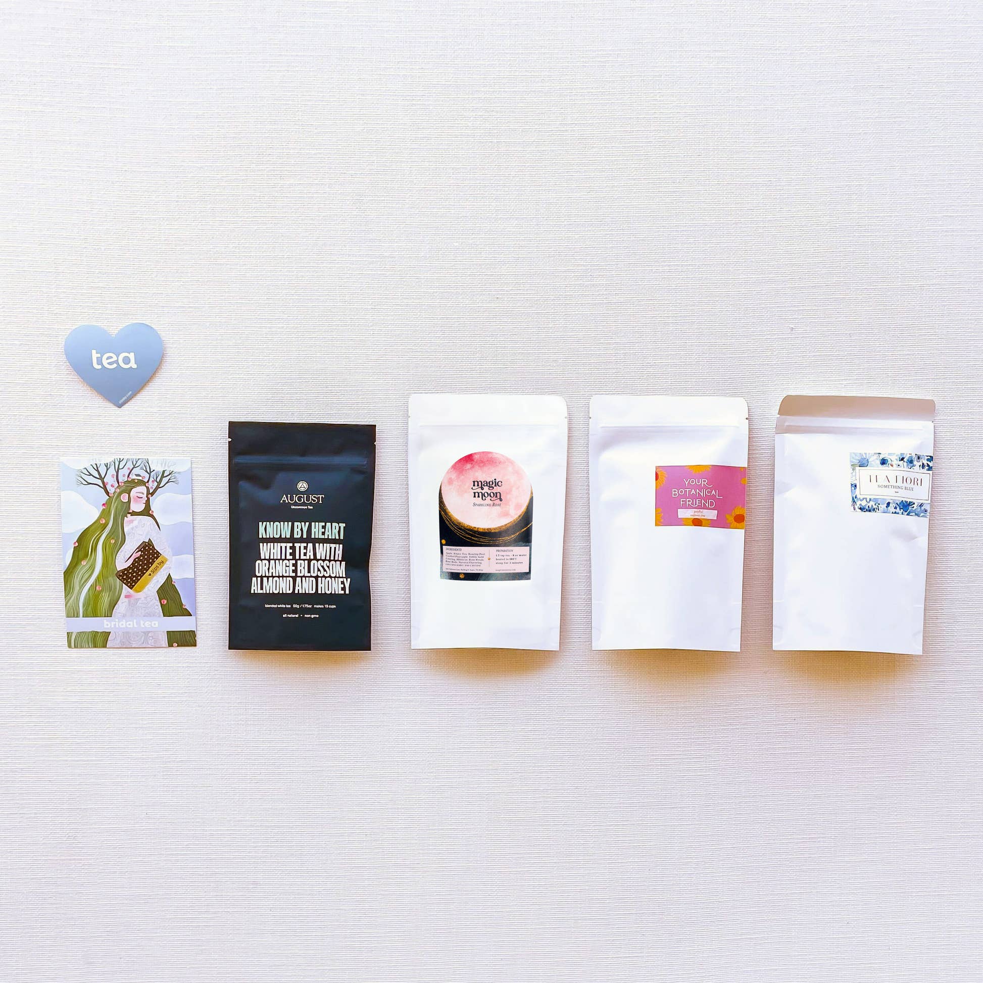Sips by Bridal Tea Collection tea packages with postcard and blue tea heart sticker