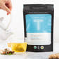 Dusk by Turmeric Teas pouch and tea sachet with steeped tea in clear cup