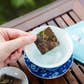 TeaVivre Fuding Shou Mei White Tea Mini Cake in a blue and white floral tea cup
